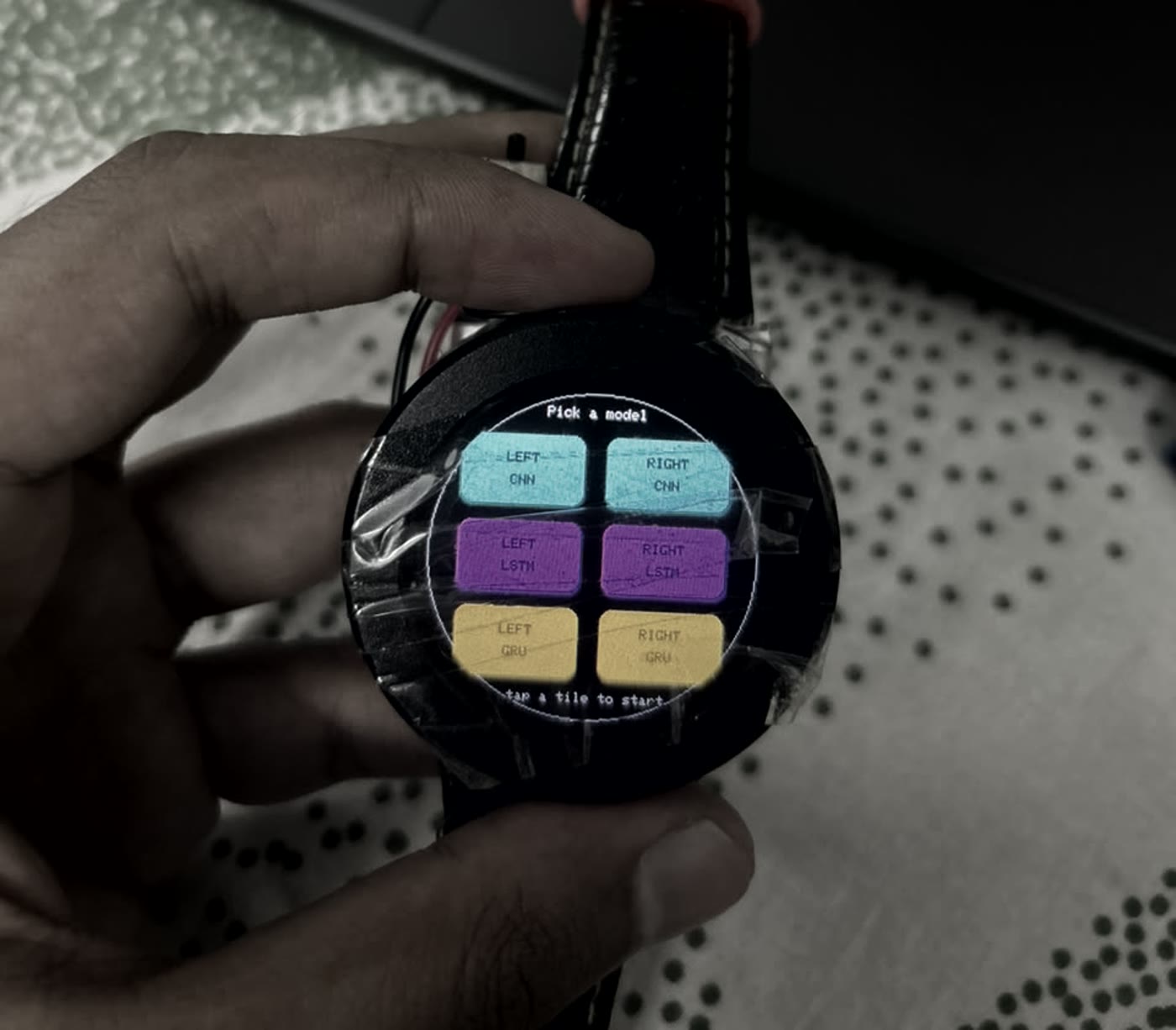 The watch showing an on-device model picker with six tiles: left and right CNN, LSTM and GRU