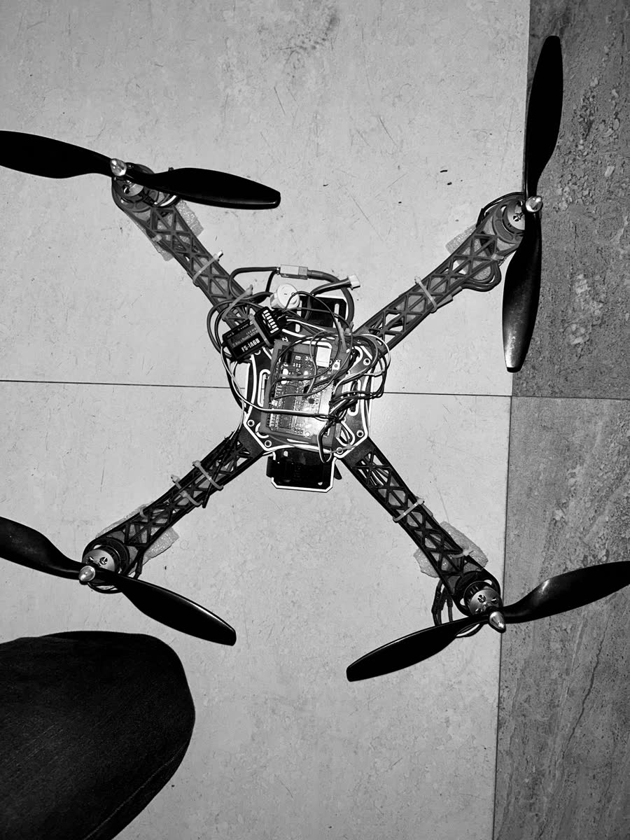Top-down view of a quadcopter airframe with motors, ESCs and wiring